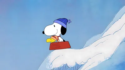 Snoopy and Woodstock sledding on a snowy hill in winter hats for PC 4K Image