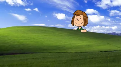 Snoopy character peeking over a lush green hill landscape for PC Wallpaper
