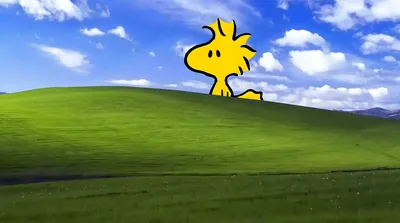 Woodstock peeking over the classic green hill and blue sky for PC Background