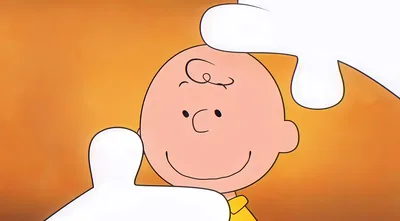 Charlie Brown smiling while Snoopy pats his head for PC Wallpaper