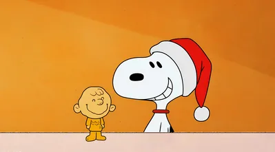 Snoopy wearing a Santa hat smiling with Charlie Brown for PC Background
