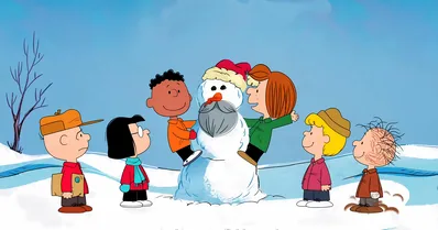 Charlie Brown and Peanuts gang decorating a Santa snowman for PC Background